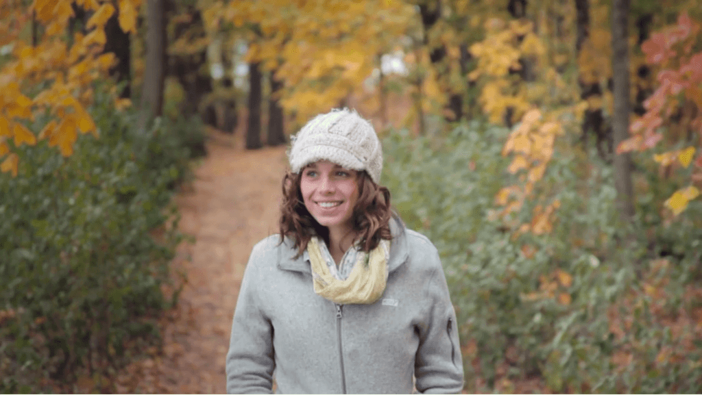 A Girl walking along a path in the fall