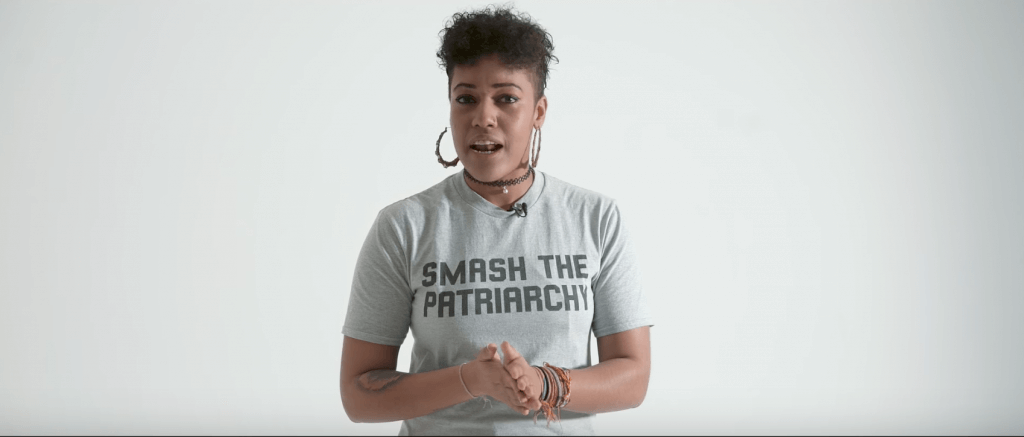 A woman stands on a white cyc background